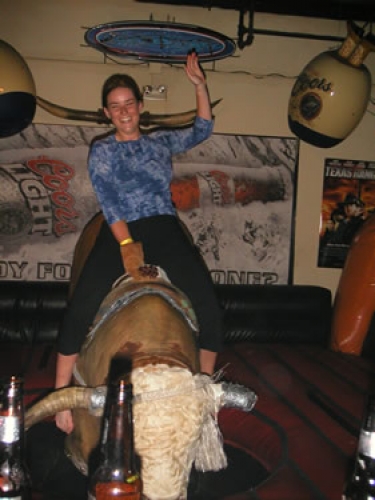 Adam and Steph ride a mechanical bull in Kansas City, MO.