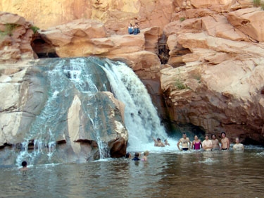 showering in a waterfall 7 miles from our capitol reef campsite