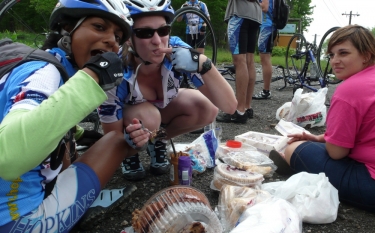 Shantha and Michelle rip into a chocolate cake as Nicole looks on.