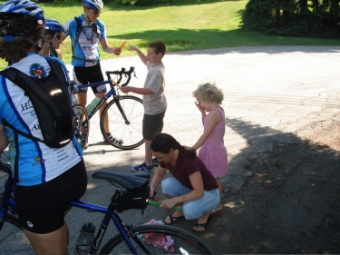 We receive some icy popsicles from a friendly family as we borrow their driveway to change a flat tire.