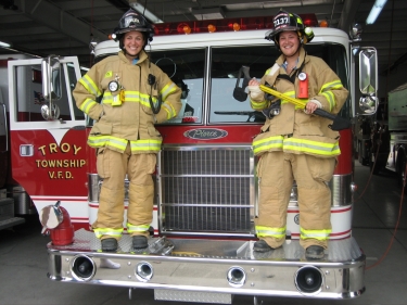 Jen and Becca try on the firefighting gear...